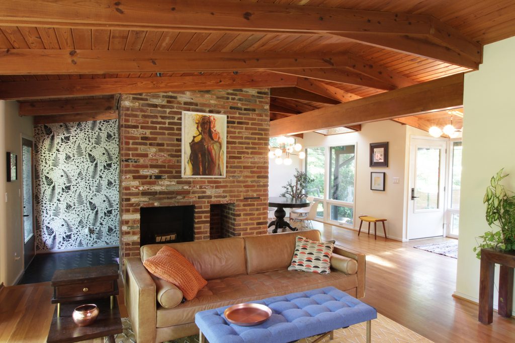 Interior view of roomy, modern, light filled, mid-century modern dining room and cathedral ceiling