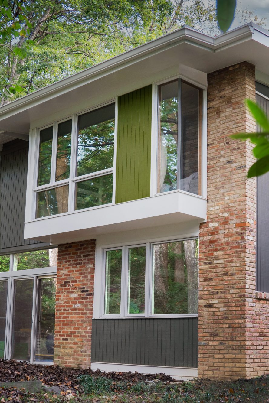 Exterior close up of new addition showing cantilevered window bay, frameless corner and color blocking. 